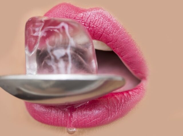 Female mouth with ice cube